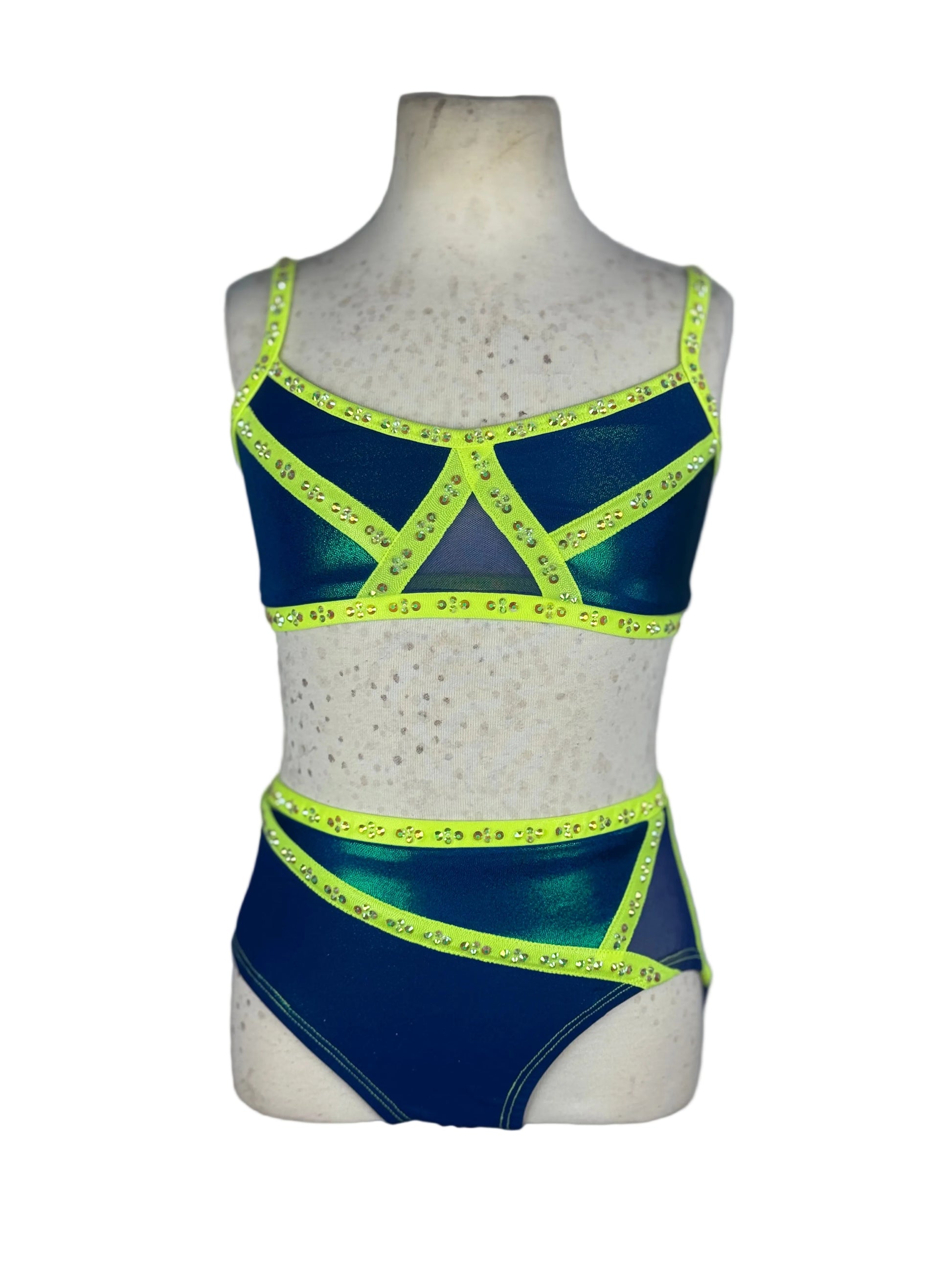 Blue and green two-piece jazz dance costume with neon accents on a mannequin against a white background
