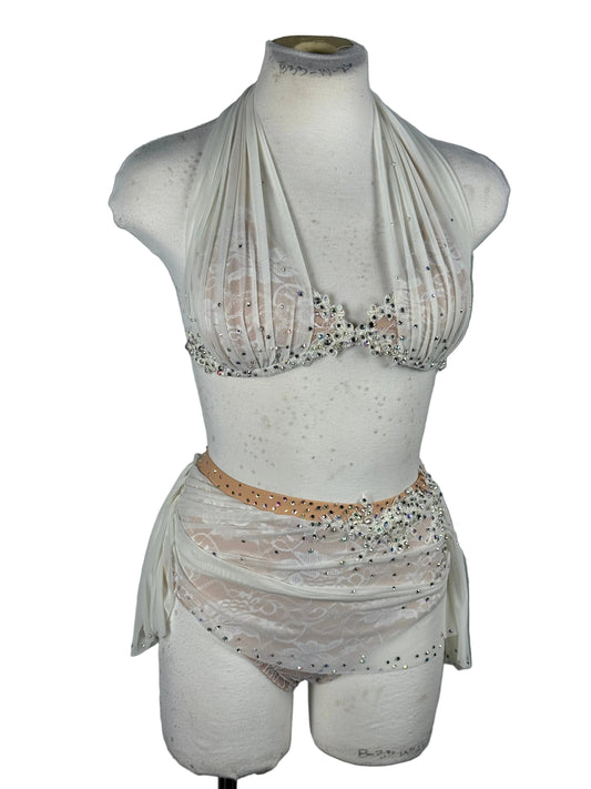 Mannequin torso wearing a white dress with lace details on a white background