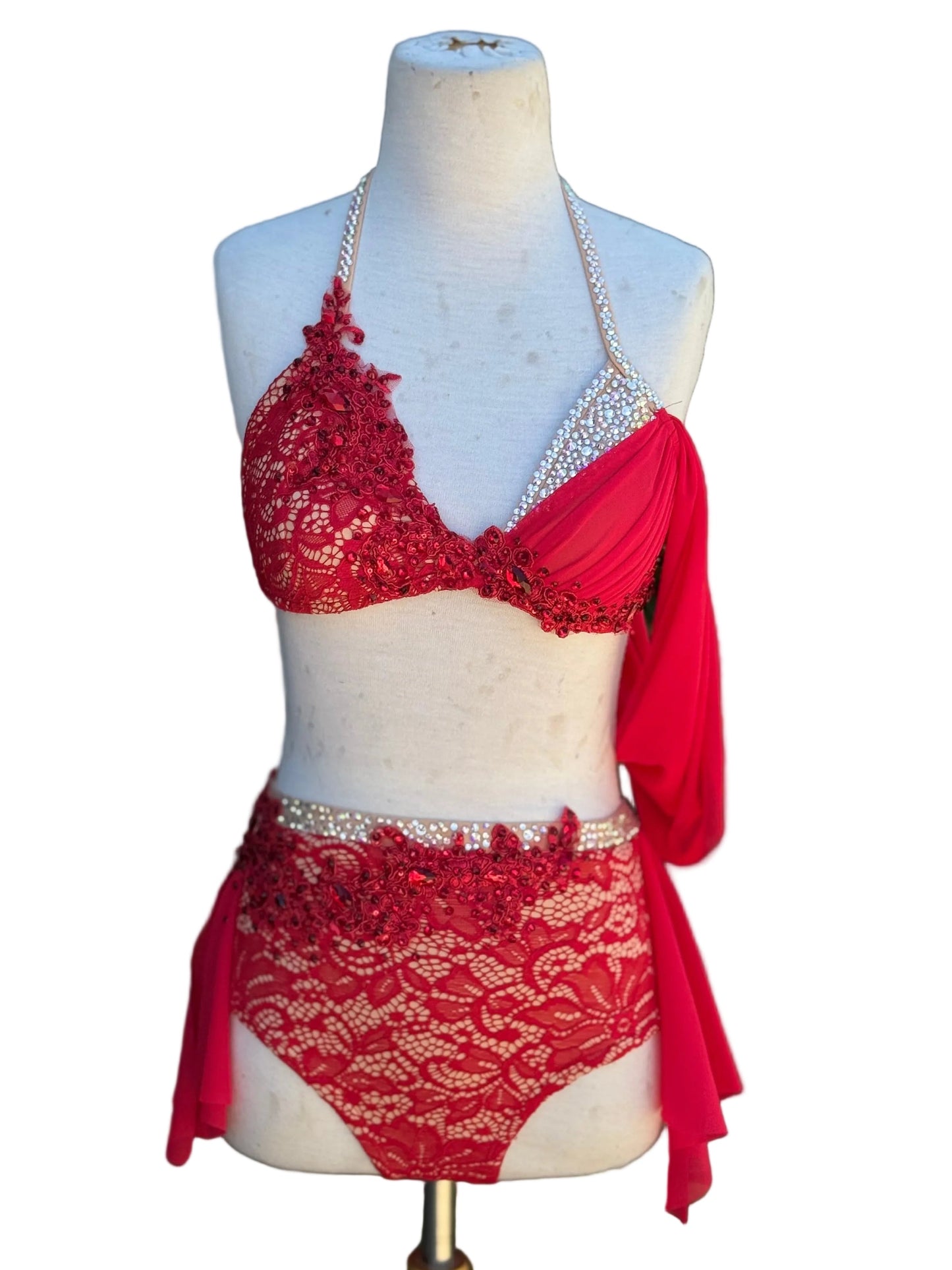 A two-piece red dance costume against a white background.