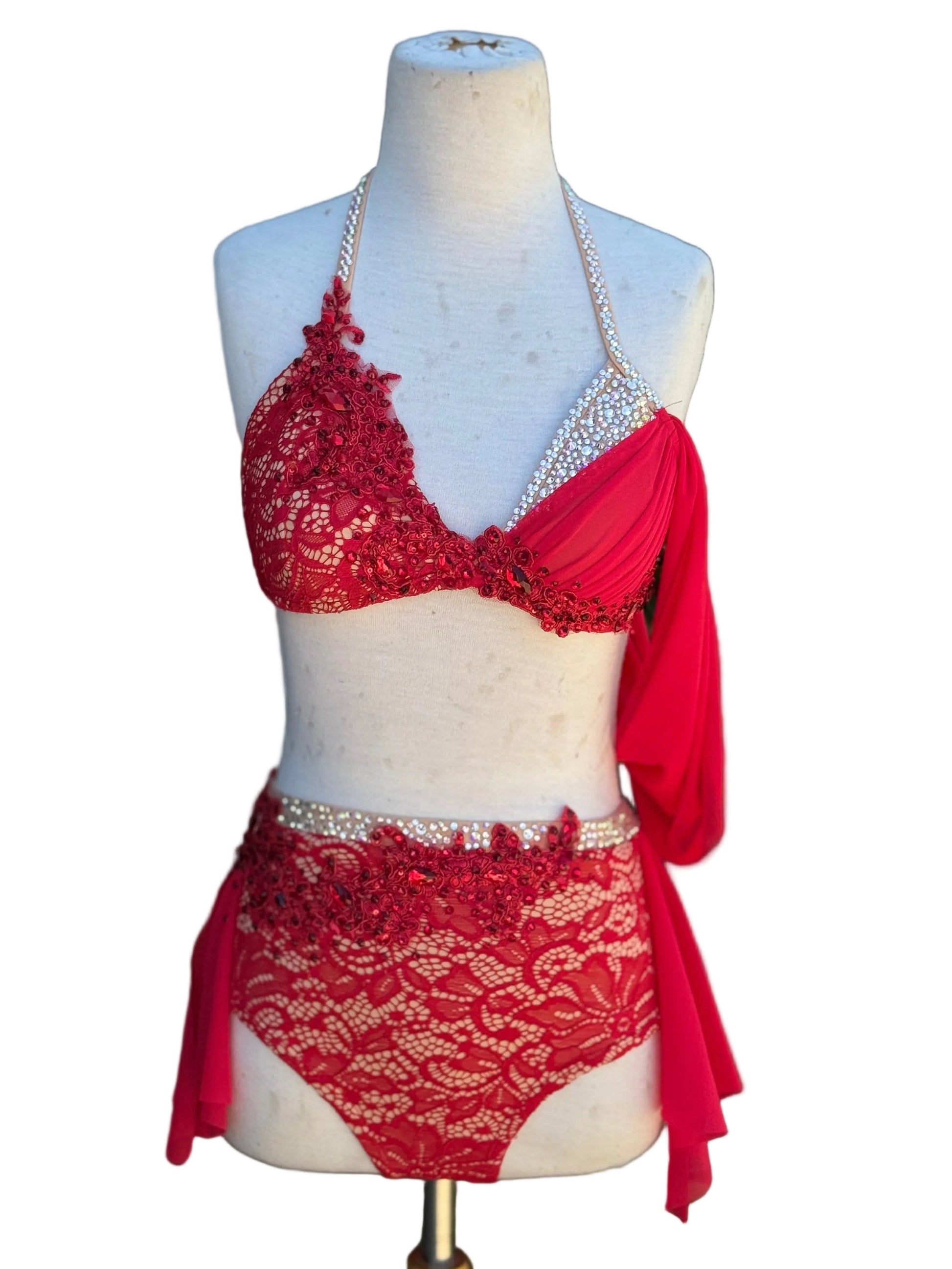 A two-piece red dance costume against a white background.