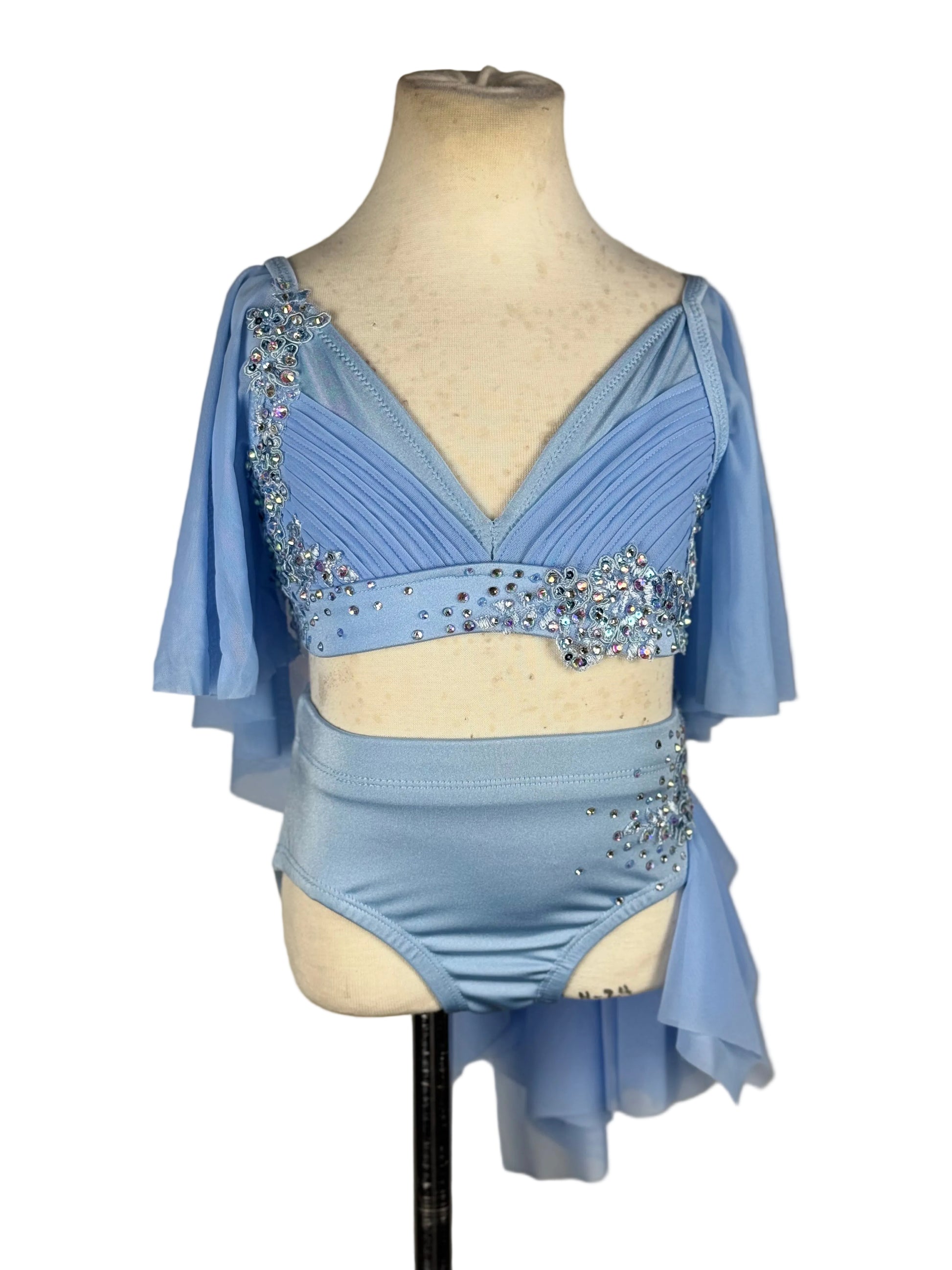 A light blue two-piece dance set displayed on a cream mannequin torso against a white background.