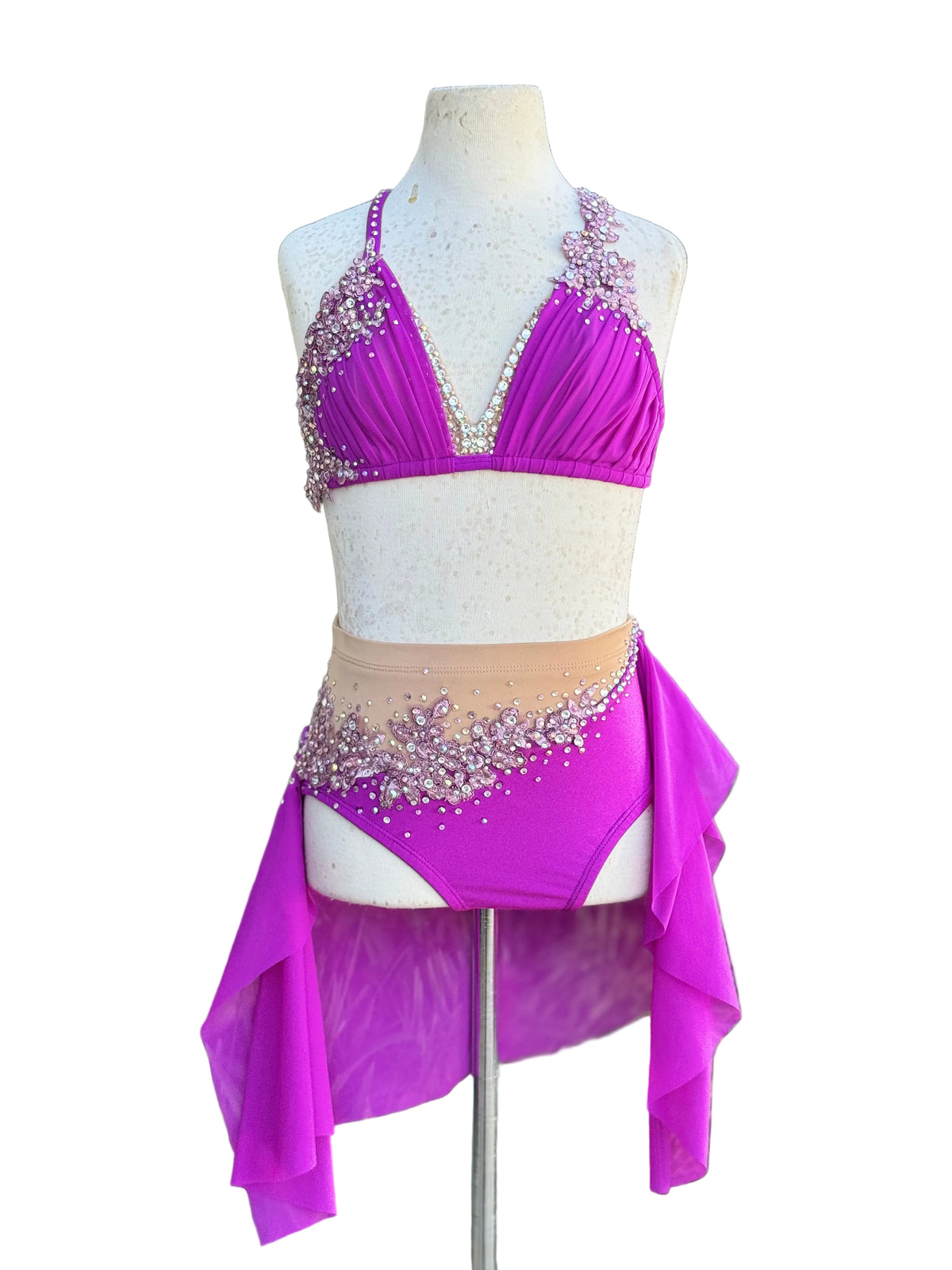 A two-piece dance set in bright magenta purple, displayed on a white mannequin torso against a white background.