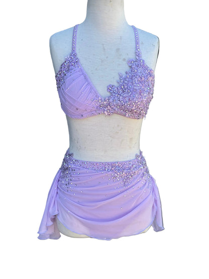 Lavender beaded top and skirt on a mannequin against white background