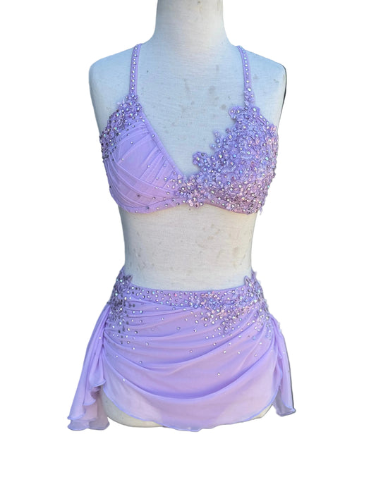 Lavender beaded top and skirt on a mannequin against white background