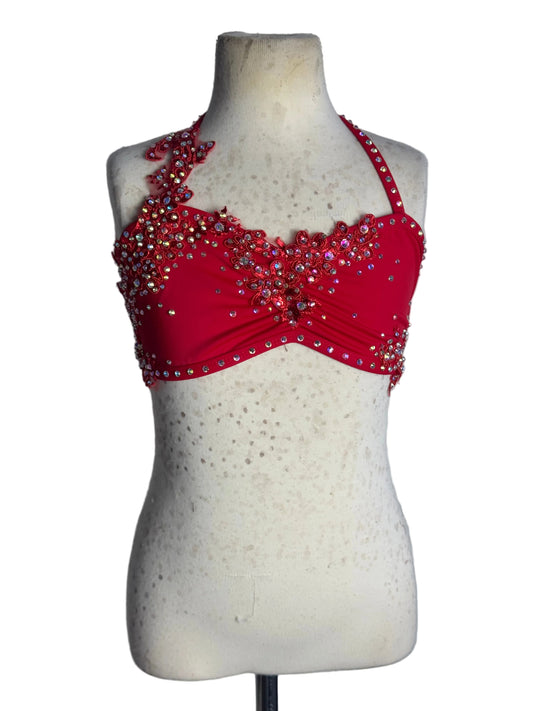 A vibrant red lyrical dance top with embellishments against a white background.
