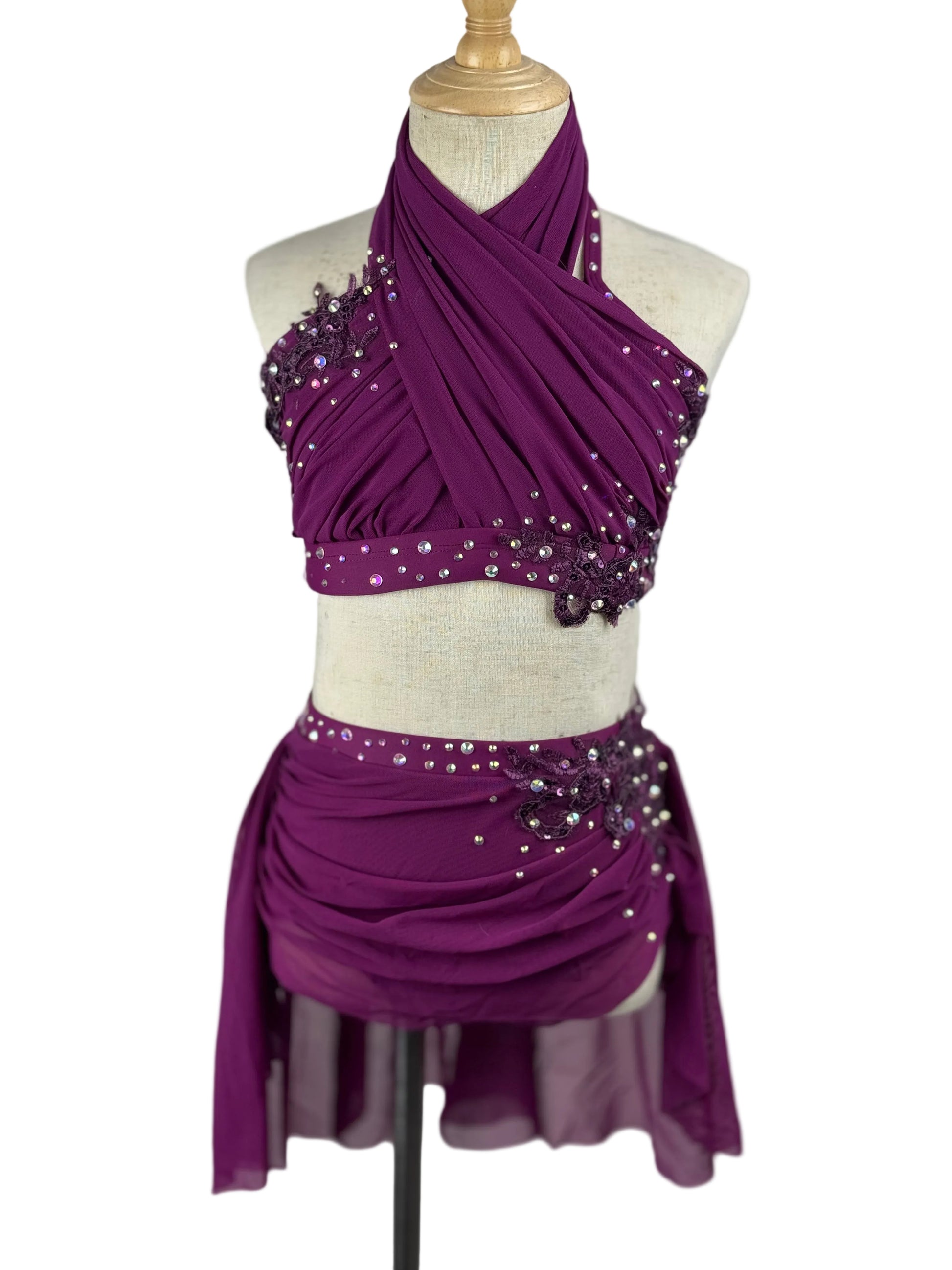 Purple lyrical dance costume with beaded details and rhinestones on a mannequin against a white background