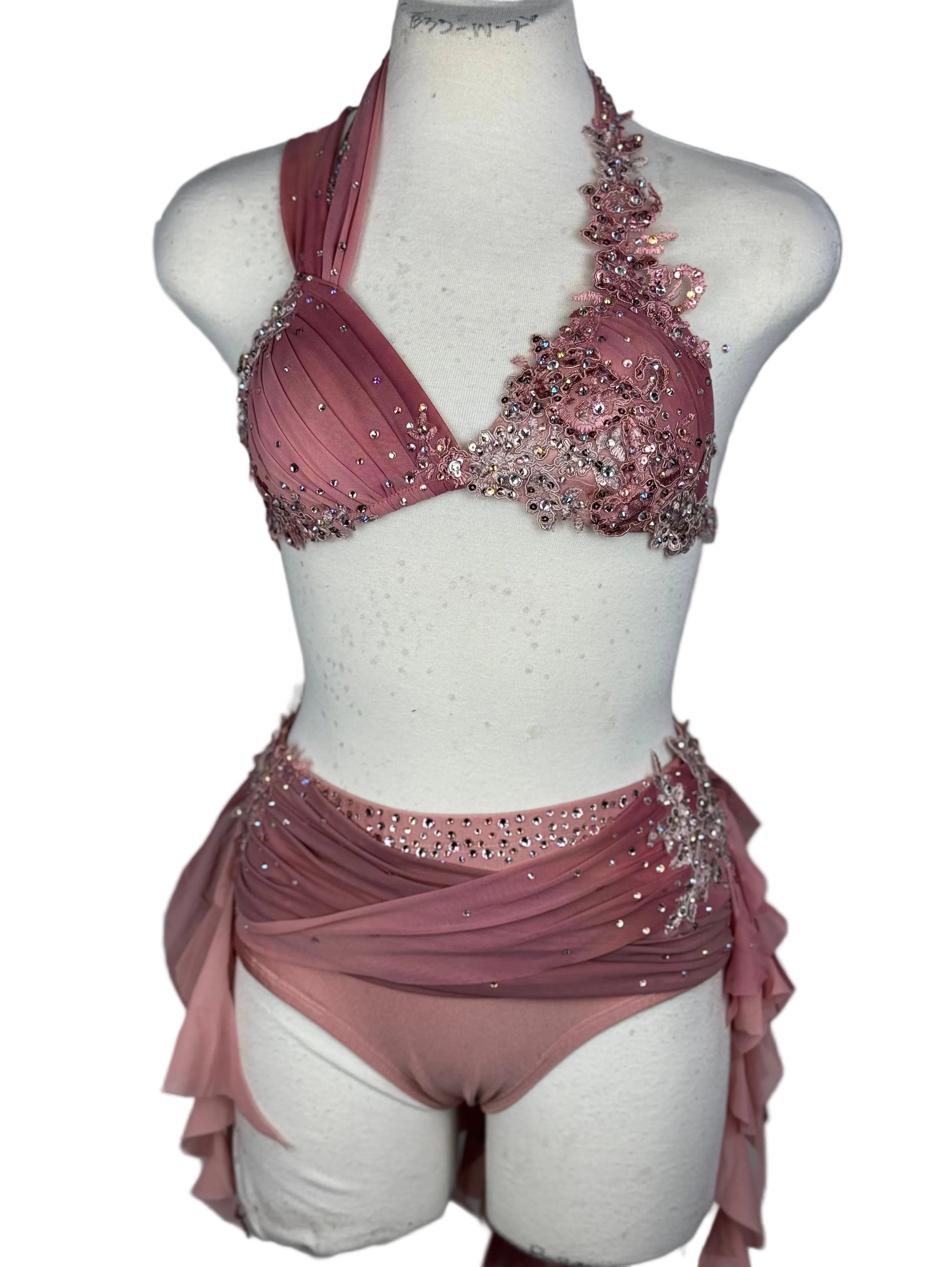 Pink beaded lyrical dance costume on a mannequin against a white background