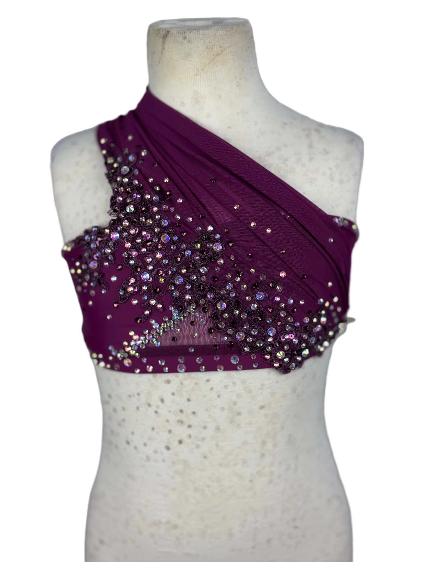 Purple one-shoulder top with sequins on a mannequin against a white background
