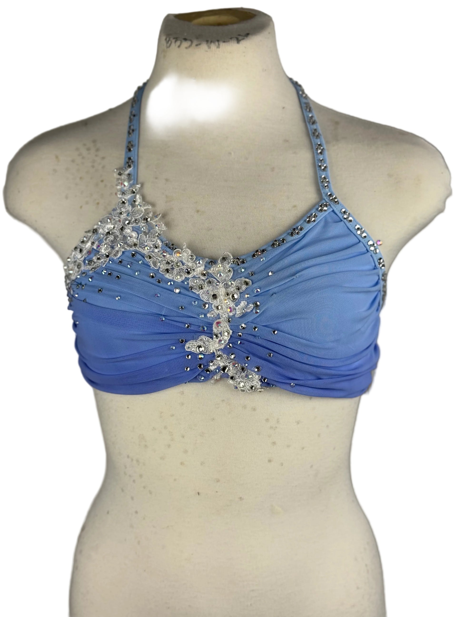 Blue lyrical dance top with crystal embellishments on a mannequin against a white background