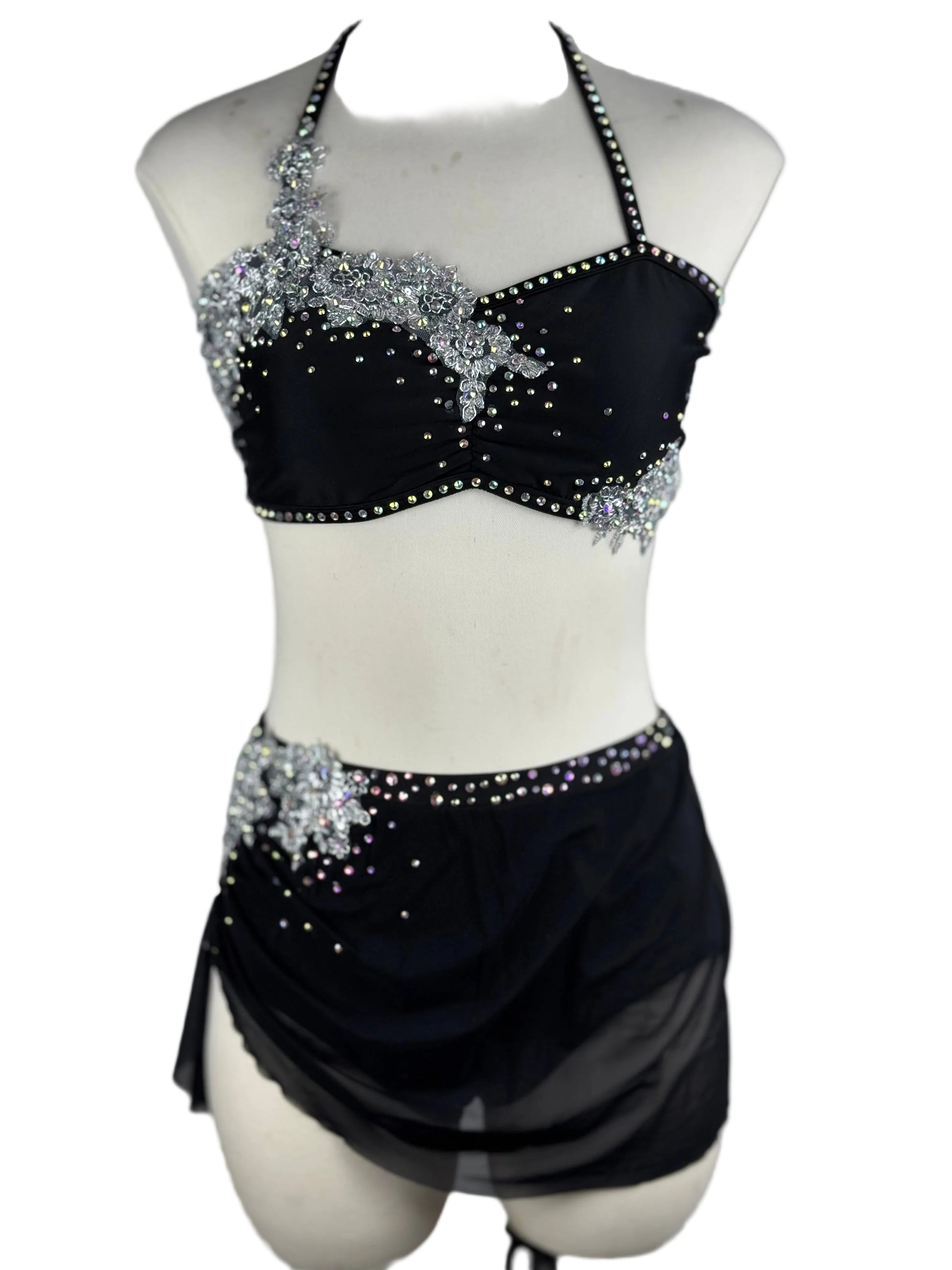 Black and silver lyrical dance costume with beaded top and skirt on a mannequin against a white background