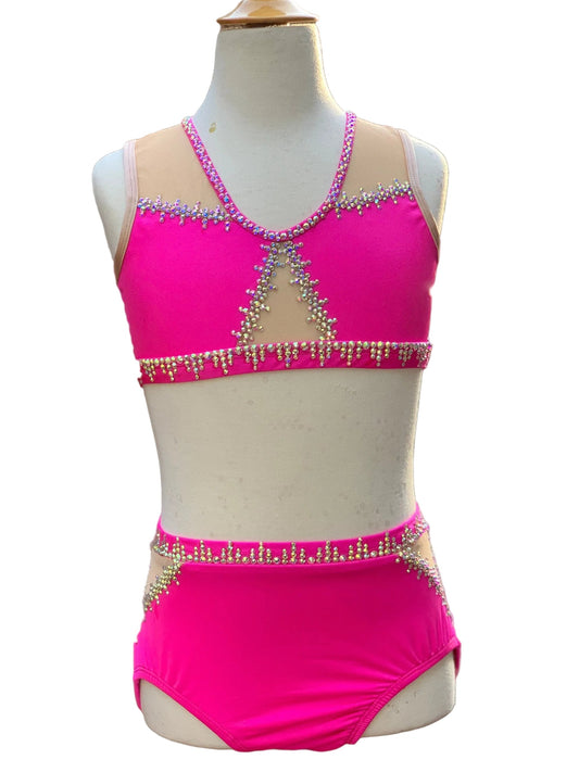 Pink two-piece jazz dance costume with embellishments on a mannequin against a white background.